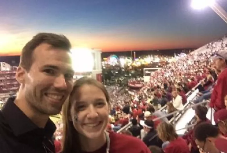 Man and woman in football stadium at twilight